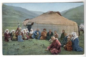 Kazakh people gathered around a yurt in a mountain landscape